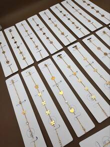 8 kiểu dáng khác nhau của dây chuyền mặt dây bằng thép không gỉ mạ vàng 18K, phù hợp cho nữ giới. Những chiếc dây chuyền mặt dây tinh tế có hình dạng cỏ ba lá, ngôi sao, trái tim và bướm, thích hợp để đeo hàng ngày hoặc làm quà tặng trang sức. - Nhiều màu - Xem 3