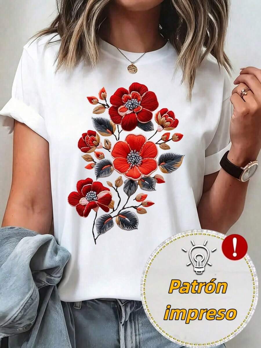 Camiseta con estampado de flores rojas, combinando tonos rojo y naranja en las flores, acompañadas de hojas negras. El diseño es vibrante y elegante, resaltando sobre un fondo blanco. Perfecta para la temporada de primavera y verano, ideal para combinar con jeans o falda corta para un estilo relajado y sofisticado. - Blanco - Ver 1