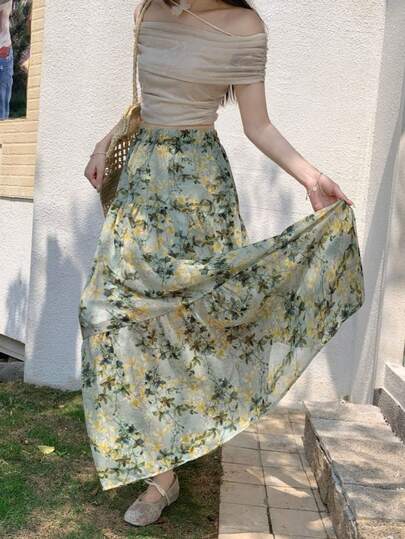 Chân váy xếp ly dáng rộng cạp cao họa tiết hoa phong cách Bohemian mùa hè 2026, kiểu dáng nhẹ nhàng đồng quê.