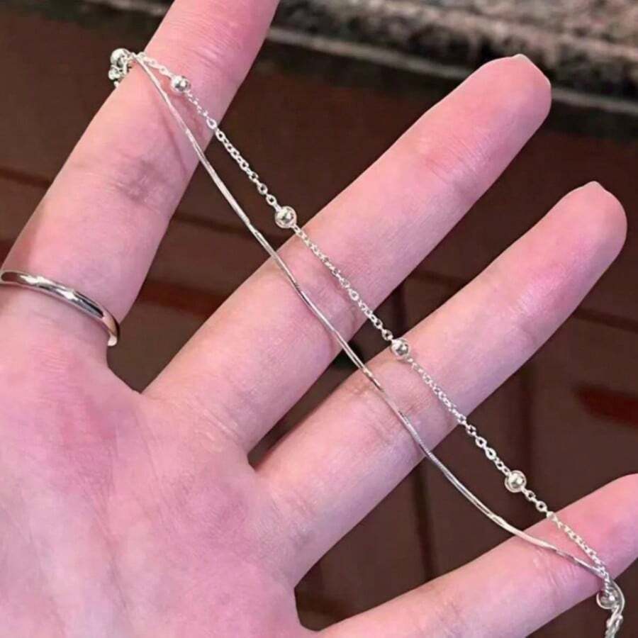 Vòng tay bầu trời sao hai lớp, nhỏ nhắn và thanh lịch, với thiết kế tối giản và trang nhã, điểm xuyết những hạt bạc sữa dành cho nữ. - Bạc - Xem 1