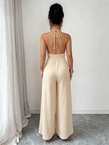 abyoxi Women's Apricot Textured Deep V-Neck Backless Jumpsuit With Handmade Beaded Tassel Decor, Pleated Waist, High-Waisted Wide Leg, Bohemian Resort, Casual Chic, Beach, Daily Wear, Spring/Summer Long Jumpsuit Elegant - Apricot - View 2