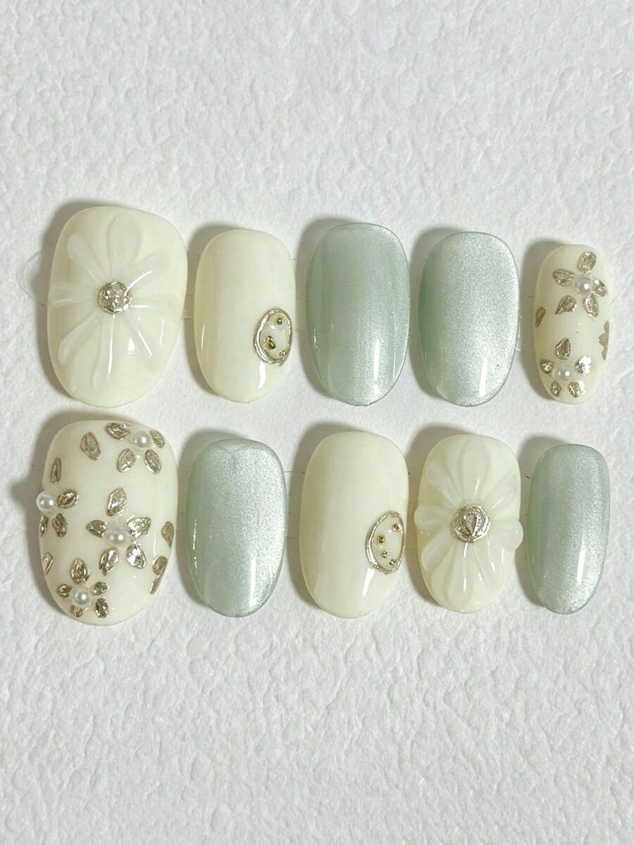 10片椭圆形美甲贴片,乳白色和浅绿色猫眼底色,饰以3D手工金色花朵和珍珠,精致奢华的可重复使用花卉图案假指甲,适合日常、约会、婚礼等场合,是送给她的理想礼物。 - 彩色 - 查看 1