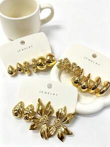 1-8对新款时尚耳环套装，款式多样，包括百合花、水滴形C型、光滑宽C型、纹理水滴形和鸢尾花左右耳佩戴款式，采用树脂材质制成。适合日常佩戴、聚会、派对和生日活动。也可作为礼物赠送给朋友、家人或母亲。 - 金色 - 查看 2