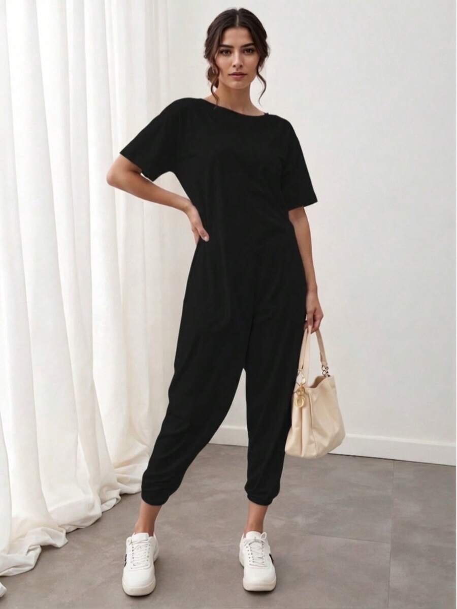Enterizo mono jumpsuit mujer dama manga corta cuello redondo corte relajado color lila bolsillos laterales tejido suave cómodo estilo casual moderno versátil para uso diario Bolsillo aberturas - Negro - Ver 1