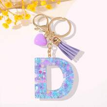 一款专为女性设计的时尚钥匙扣。这款树脂字母钥匙扣配有紫色链条、紫色心形流苏和精美亮片。 - 紫色 - 查看 10