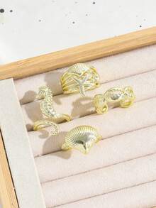 Set de 4 anillos apilables con diseños de la serie oceánica estilo INS, incluyendo caballito de mar, estrella de mar, concha y caracol, para mujeres - Dorado - Ver 3