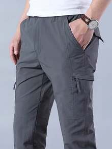 Pantalones de trabajo pantalones al aire libre pantalones de trabajo resistentes al desgaste pantalones de entrenamiento pantalones tácticos de la compañía masculina pantalones de primavera y otoño turismo pantalones al aire libre resistentes al desgaste y flexibilización de múltiples bolsillos - humo gris - Ver 1