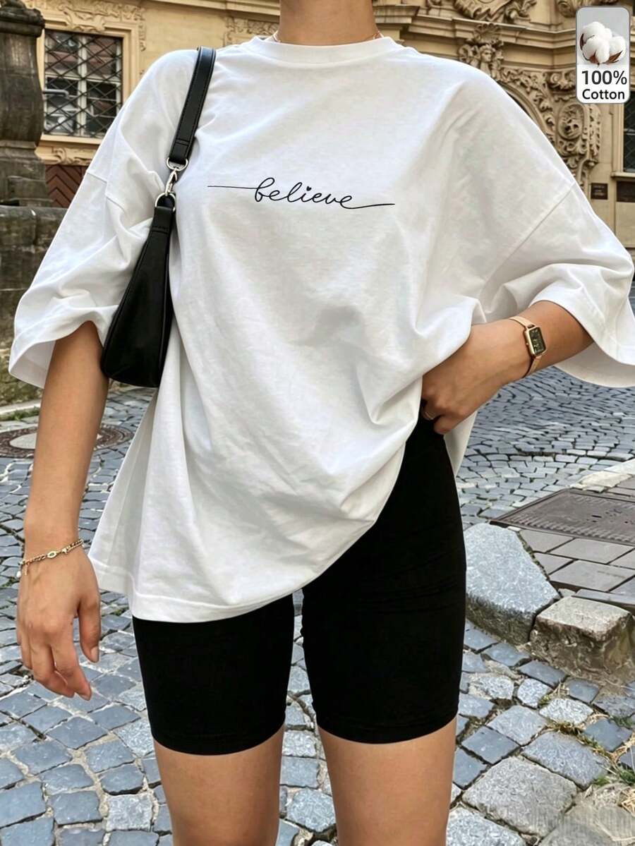 T-shirt décontracté pour femme blanc avec imprimé << Believe », épaules tombantes, manches courtes, col rond, top long en coton pour le streetwear quotidien, l'extérieur, Y2K - Blanc - Voir 1