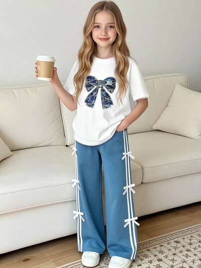 Set de 2 piezas de camiseta de cuello redondo con estampado de lazo y pantalones deportivos sueltos con decoración de lazo, de unicolor y estilo casual para niñas, para verano