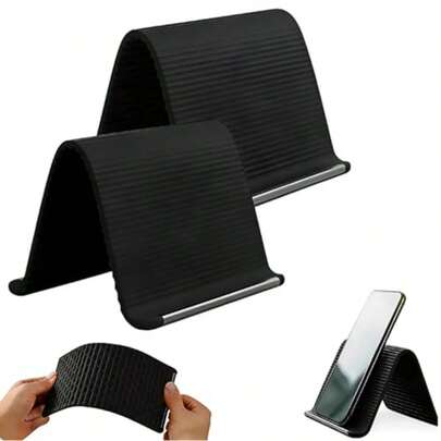 A Portable, Foldable, Silicone-Aluminum Phone Stand With An Orange And Black Design. The 2026 New Flexible Silicone Phone Stand, Adjustable Airplane-Style Phone Stand, Suitable For All Types Of Phones, Tablets, Laptops, Desks, Travel, Portable Beds, Offices, And Running Machines. K-8