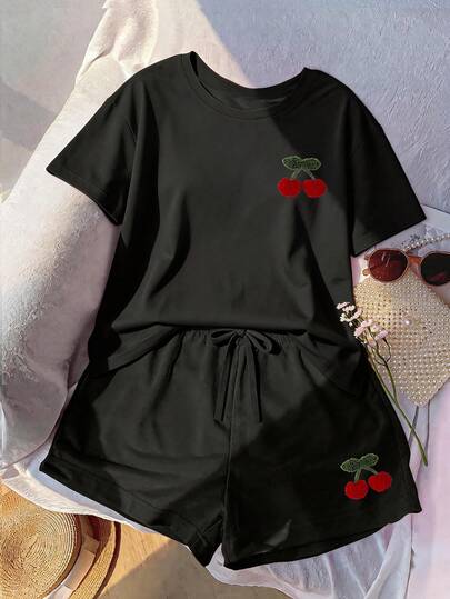 Bộ đồ nữ cỡ lớn thêu hình quả anh đào đen, cổ tròn và quần short có dây rút, chất liệu co giãn vừa phải.