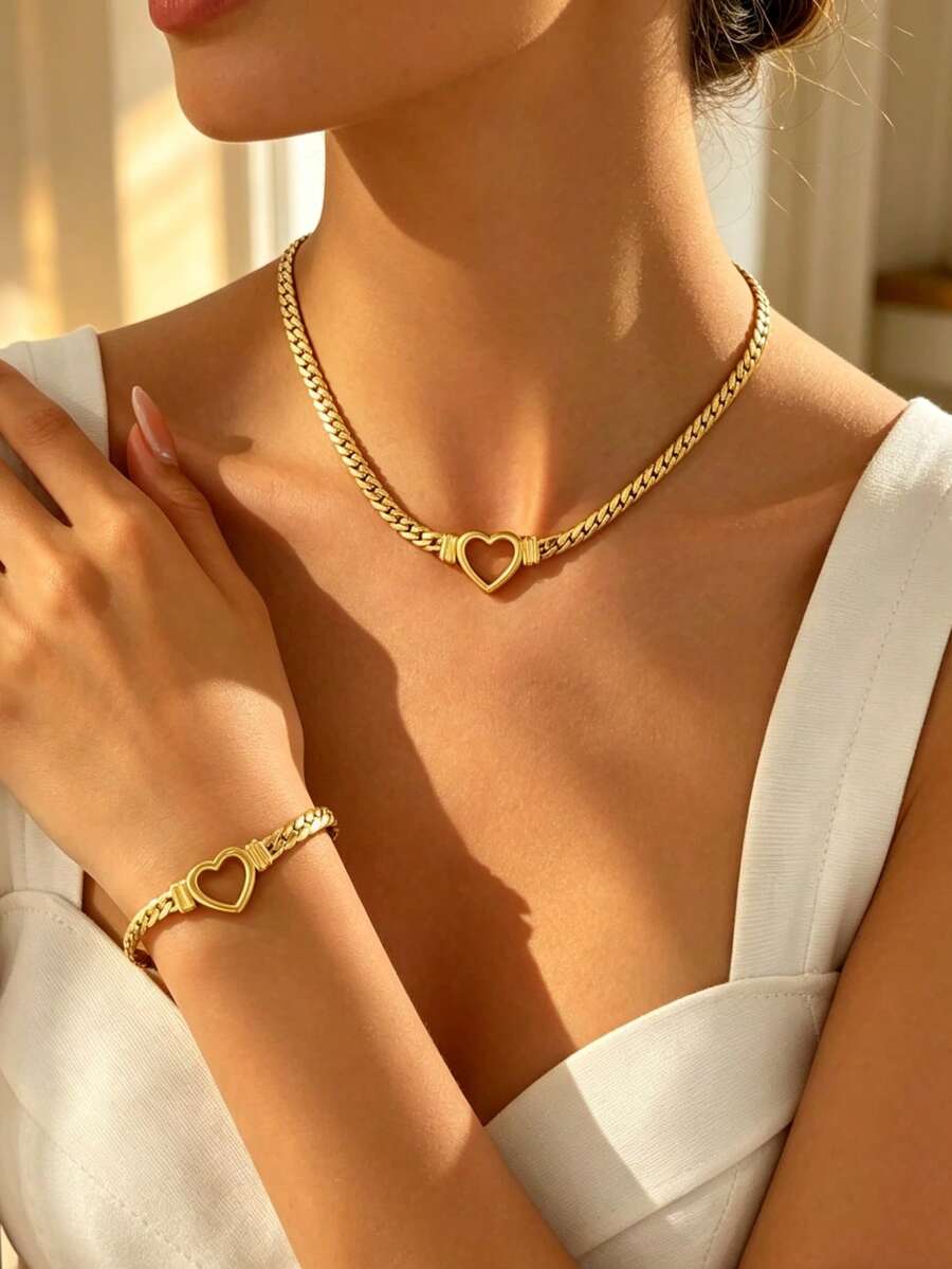 Bộ trang sức tối giản bằng thép không gỉ gồm dây chuyền và vòng tay, thiết kế hình trái tim rỗng, thích hợp cho nữ giới đeo đi dự tiệc, họp mặt, du lịch hoặc những buổi đi chơi thời trang. - Vàng - Xem 1