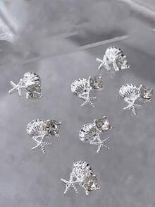 10 pièces Charms d'art des ongles à thème estival, avec des motifs d'étoiles de mer et de coquillages comme designs principaux. La collection comprend une variété de styles, y compris des designs en or, argent, perle, étoile de mer et coquillage. Ces décorations d'ongles en alliage 3D. - Multicolore - Voir 5