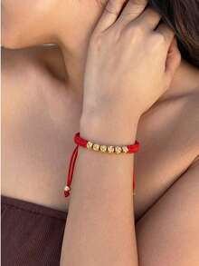 1 chiếc vòng tay điều chỉnh được, làm từ sợi ngọc bích, đính hạt hình hoa cắt vàng 4mm. - Đỏ - Xem 2