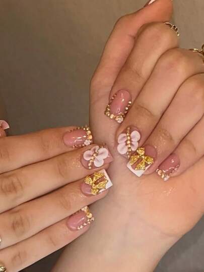 10pcs Set Nude Pink French Style Artificial Nails - These Medium-Length Rectangular Fake Nails Feature 3D Pink Floral Decor And V-Shaped Golden Rhinestones. With A Glossy Finish, Reusable, And Exuding A Sweet, Elegant Style, Suitable For Ladies And Teenage Girls To Wear Daily, On Dates, Parties, Weddings, And Various Occasions.