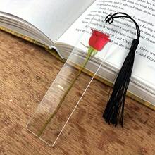 Một chiếc kẹp sách bằng acrylic trong suốt cỡ lớn họa tiết hoa hồng, kèm tua rua màu đen, là lựa chọn lý tưởng cho những người yêu thích đọc sách và cũng có thể dùng làm quà tặng Ngày Valentine hoặc sinh nhật. - Hình chữ nhật - Xem 1