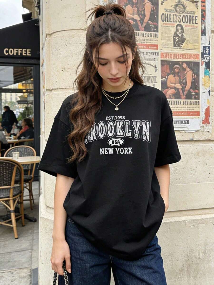 Camiseta de manga corta con cuello redondo suave y casual para mujer, estampado gráfico vintage desgastado de Brooklyn, Nueva York, EE. UU., fundada en 1998, adecuada para uso diario. Color blanco. - Negro - Ver 1