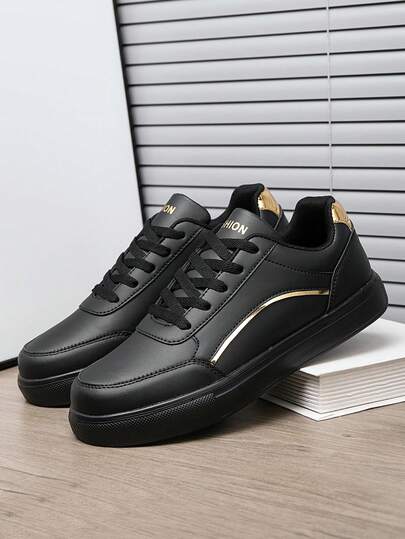 Zapatillas deportivas casuales de corte bajo con empalmado de PU negro y franja dorada, con acento metálico llamativo, versátiles para uso diario casual unisex