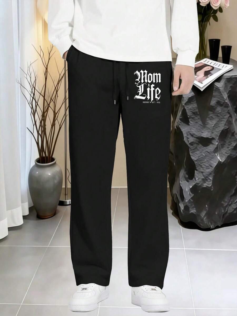A pair of Mom Life Gothic Typography Print men's black drawstring waist wide-leg sweatpants, loose straight-leg pants with side pockets, ultra-comfortable breathable fabric, suitable for year-round sports, daily wear, and street-style casual wear. - ブラック - チェックする 1