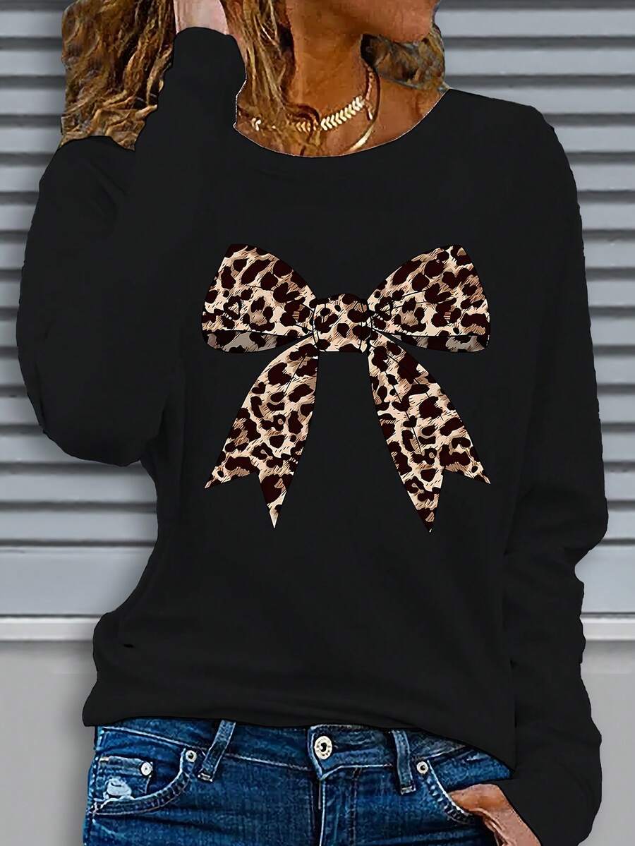 Camiseta de manga larga suelta de moda para mujeres con diseño de arco con estampado de leopardo y cuello redondo, de moda y elegante. Hecho de tela ligeramente elástica, adecuado para usar en todas las estaciones. Pesa 180G por metro cuadrado