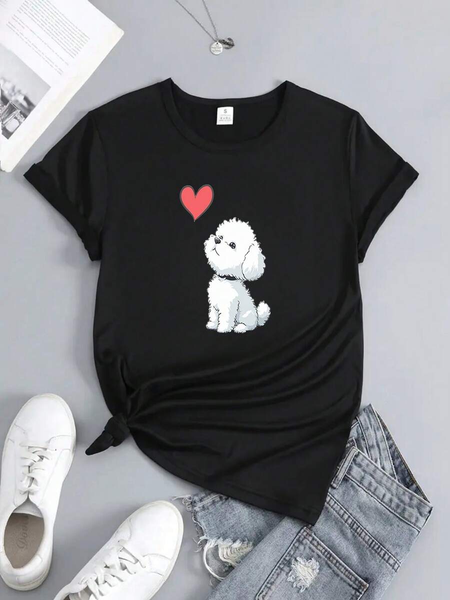 Un pequeño friso de bichon femenino está mirando a una sudadera en forma de corazón. Un regalo de manga corta para el día de la madre