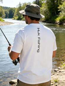 Unisex White Huk Fishing T-Shirt With Black Front Logo And Vertical "Huk Fishing" Back Print, Lightweight Casual Crewneck Tee For Anglers, Perfect For Fishing Trips, Outdoor Activities And Everyday Streetwear. - White - View 1