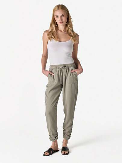 Koroshi Jogger Pants, 100% Lyocell, Khaki. Sizes 34/36/38/40/42/44. High-Waisted Design That Flatters The Figure, With An Adjustable Elastic Waistband And Drawstring For A Customized Fit. Features Functional Front And Back Ribbed Pockets For Added Convenience.