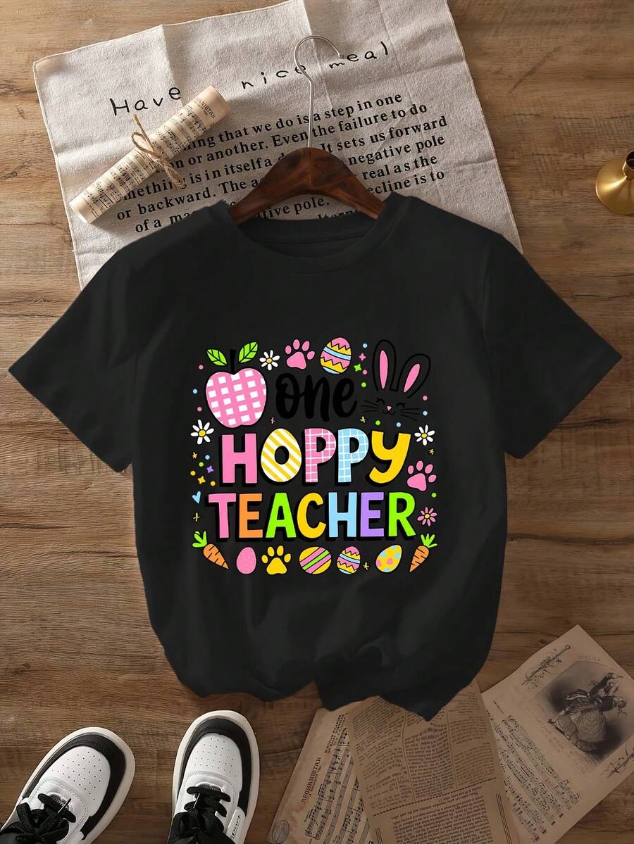 Camiseta gráfica para mujer "A Happy Teacher" - Manga corta, cuello redondo, top casual de verano y primavera, con diseño de conejo de Pascua y huevo, tejido de poliéster, 180g/m², para uso casual. |   Estampados Divertidos |   Confección cosida, regalo para profesores - Camiseta unisex de algodón de manga corta y cuello redondo, estilo vintage urbano. - Negro - Ver 1