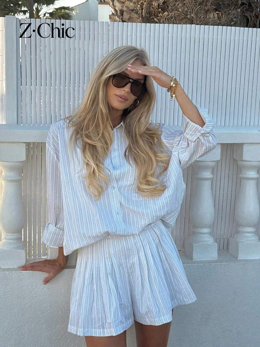 Bộ đồ nữ 2 món: Quần short xếp ly cạp cao đa năng mùa xuân/hè/thu + Áo sơ mi dài tay kẻ sọc, trang phục kẻ sọc mùa xuân/hè mới, phù hợp cho công sở, đi chơi, du lịch, học đường. Áo sơ mi kẻ sọc thanh lịch với cúc cài phía trước và túi, cùng bộ quần short. - Màu xanh nhạt - Xem 1