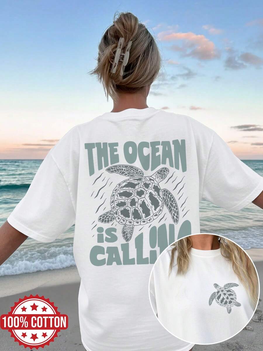 Reversible Printed T-Shirt For Women, Perfect For Spring And Summer. A Versatile And Stylish Top With A Vintage Design Featuring Sea Turtles And Ocean Elements. This Crew Neck, Short-Sleeved, Oversized T-Shirt Features The Slogan 'THE OCEAN IS CALLING'.