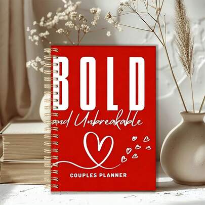 1 cuốn sổ tay lập kế hoạch cặp đôi khổ A5, gáy xoắn, bìa đỏ "Bold And Unbreakable" dùng để lên kế hoạch cho mối quan hệ và các buổi hẹn hò.