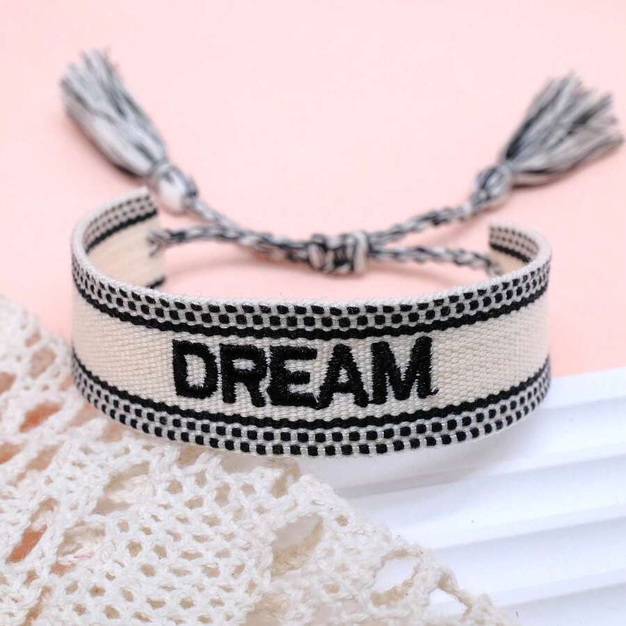 1条绣有“DREAM”字母的手工编织休闲可调节手链，适合派对和日常佩戴。 - 黑與白 - 查看 1