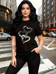 El epítome de "emoción y amor", esta camiseta de manga corta para mujer presenta un estampado de corazón metálico, moderno y a la moda, con un cuello redondo sencillo y un diseño casual versátil, adecuada para el ocio, viajes, vacaciones y otras actividades. - Negro - Ver 2