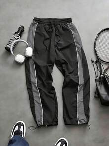 Quần jogger nam dáng rộng, chất liệu nylon nhăn, có dây rút ở eo, phối màu bên hông và đường may nổi bật, phong cách đường phố năng động, thích hợp mặc hàng ngày, mùa xuân/hè. - Xám - Xem 1