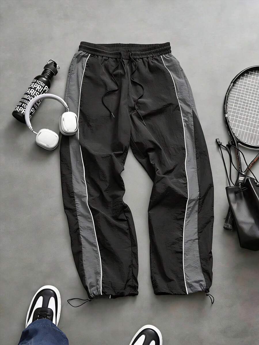 Quần jogger nam dáng rộng, chất liệu nylon nhăn, có dây rút ở eo, phối màu bên hông và đường may nổi bật, phong cách đường phố năng động, thích hợp mặc hàng ngày, mùa xuân/hè. - Xám - Xem 1