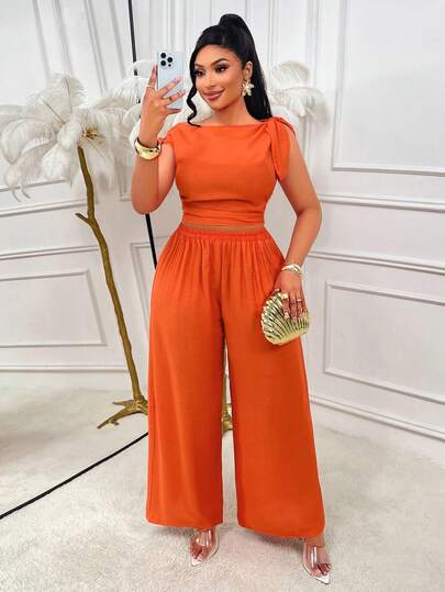 Bộ đồ 2 món nữ màu cam phong cách thường ngày, size lớn, áo blouse nơ bất đối xứng phối quần xếp ly eo, thanh lịch, phù hợp đi hẹn hò và mặc hàng ngày