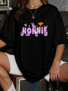 Colorful Design With Large Lettering Decorated With Purple Cartoon Characters That Convey Joy And Youthful Energy. Casual Women's T-Shirt With A Fun Print And Urban Touch. - 黑色 - 查看 1