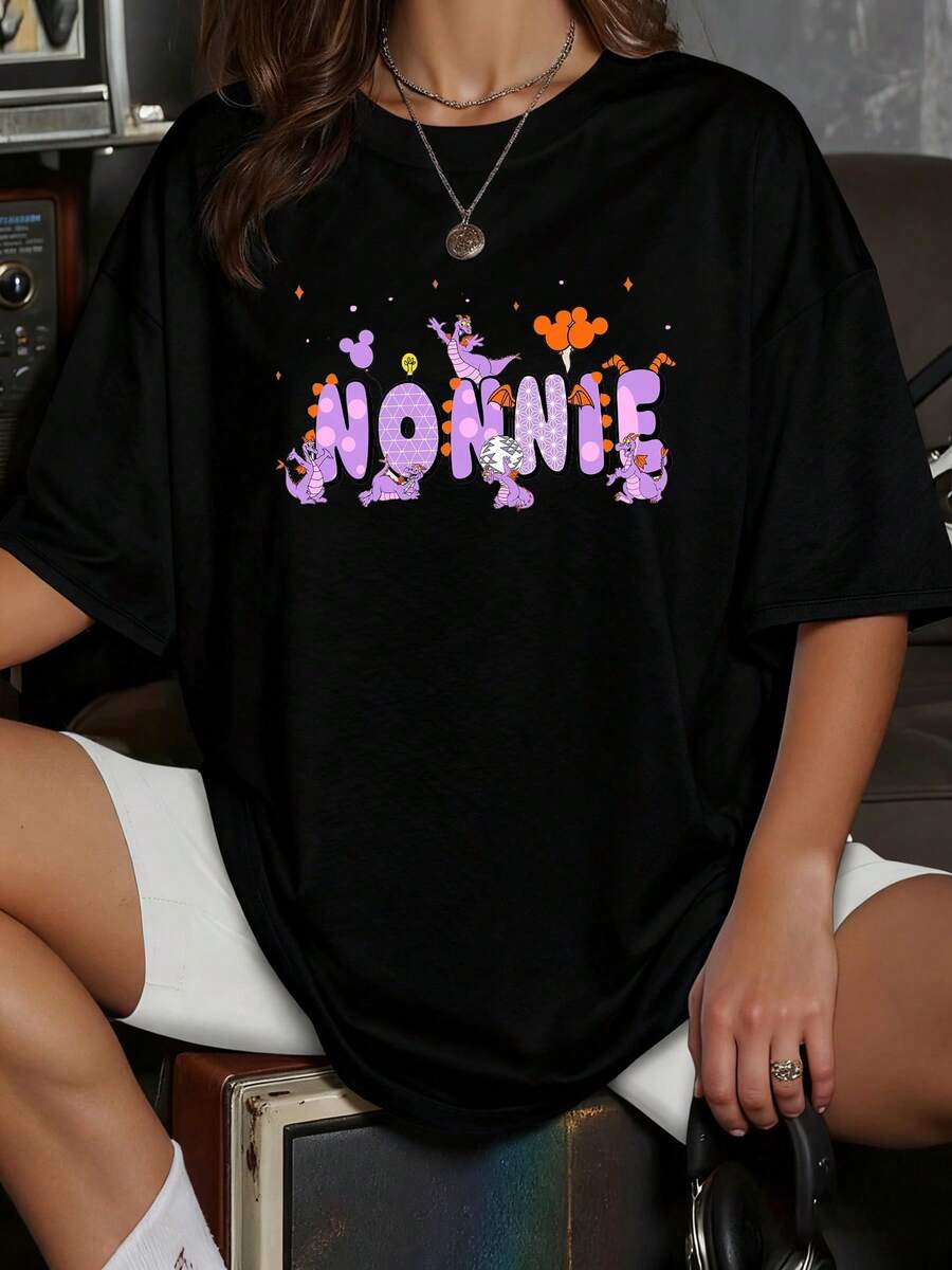 Colorful Design With Large Lettering Decorated With Purple Cartoon Characters That Convey Joy And Youthful Energy. Casual Women's T-Shirt With A Fun Print And Urban Touch. - 黑色 - 查看 1