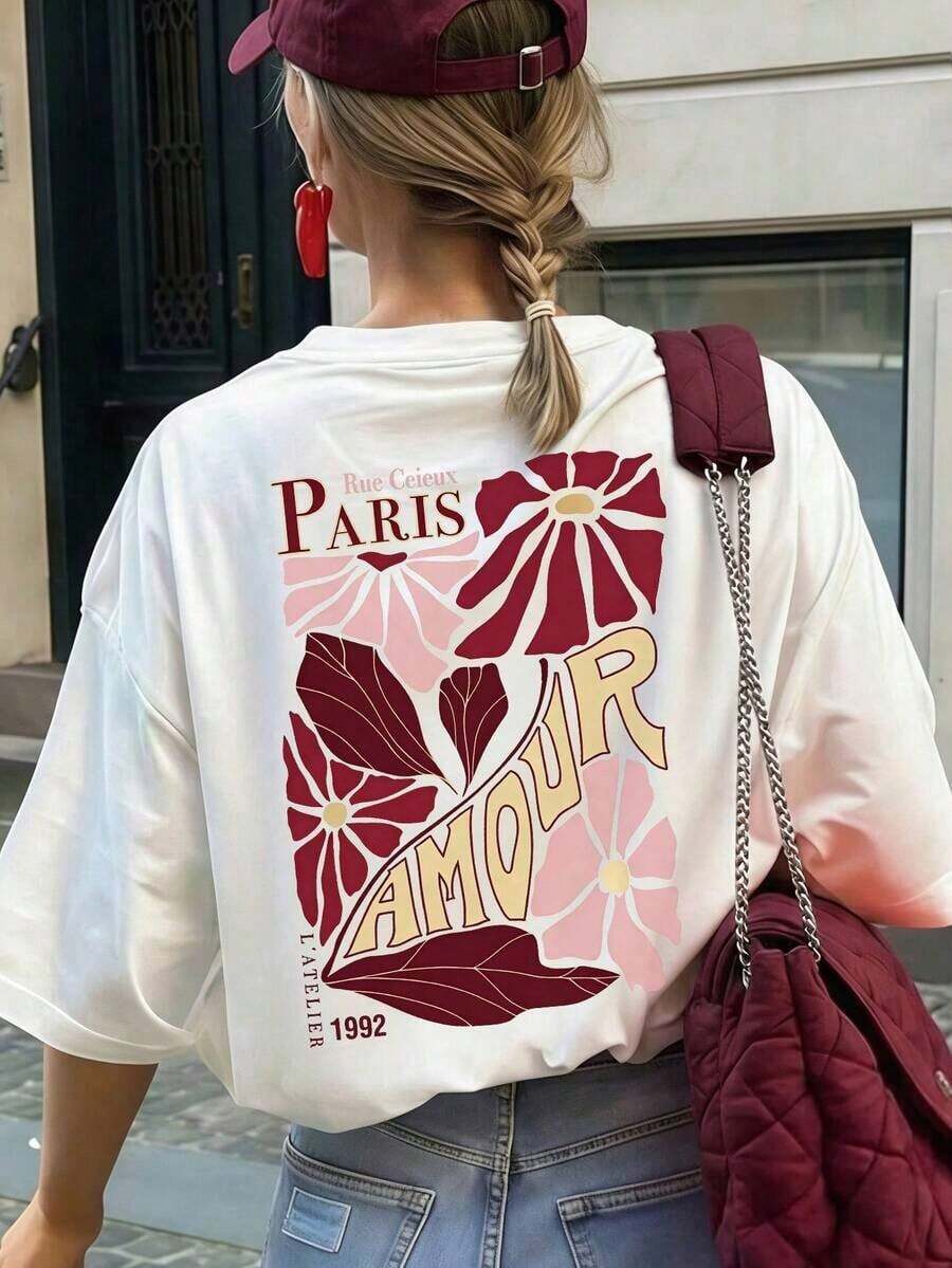 Kvinnors krämfärgade, löst sittande "Paris Love"-t-shirt med blommönster, rund halsringning och korta ärmar, avslappnad passform, parisisk stil, romantisk, stadspromenad, dejtkväll, körsbärsblomssäsong, brunch-outfit, vår-/sommarlov, vit sommaroutfit för kvinnor. - Weiss - Visa 1