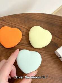 1 cái giá đỡ điện thoại hình trái tim bằng silicon màu trơn, có thể mở rộng để xem video trên bàn. - Nhiều màu - Xem 3