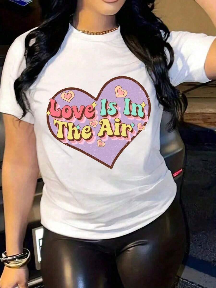 1 pieza de camiseta estampada para mujer, nueva, para el Día de San Valentín, con el texto "El Amor Está en el Aire", corazón morado grande con contorno marrón y corazones rosados pequeños, letras coloridas, cuello redondo, manga corta, tela suave y cómoda, corte holgado, lavable a máquina, ropa casual y de exterior a la moda, top minimalista y elegante, 180g 100% algodón. - Blanco - Ver 1