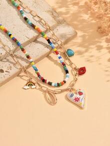 两件套趣味首饰，包含彩色彩绘爱心、红唇、贝壳、彩虹爱心、绿松石吊坠项链组合，以及彩色串珠颈链，适合女性日常佩戴、街头风、派对、节日等场合。串珠项链的颜色排列随机。 - 多色 - 查看 3