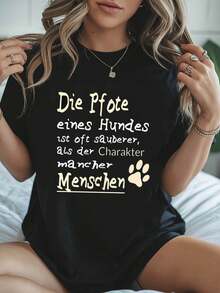 Reflexiones 2026: Huellas de perro y carácter. Dicho alemán: "La pata de un perro a menudo es más limpia que el carácter de algunas personas." Camiseta de mujer holgada, informal, de cuello redondo, para primavera-verano, con estampado de huellas de perro. - Negro - Ver 1