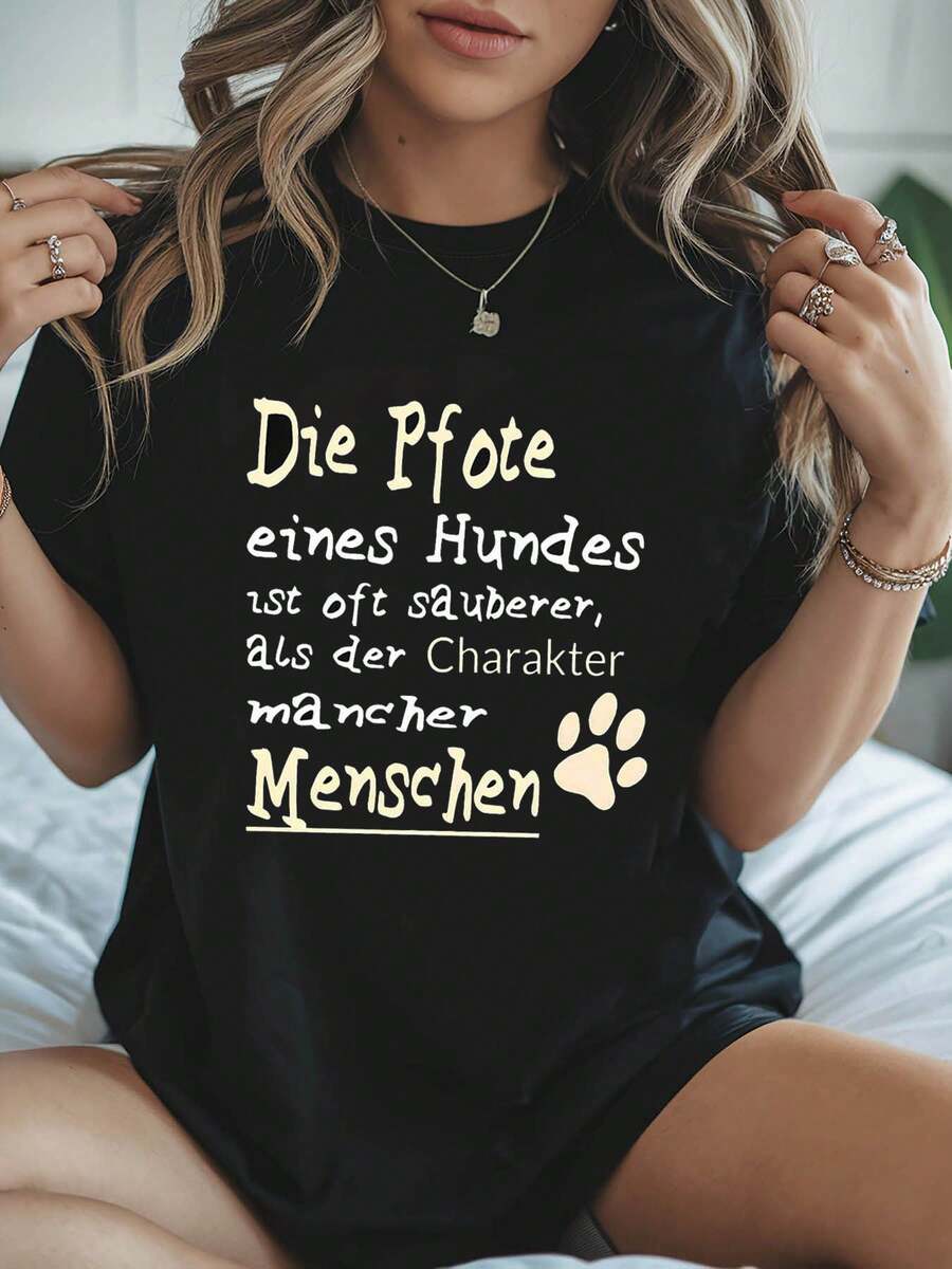 Reflexiones 2026: Huellas de perro y carácter. Dicho alemán: "La pata de un perro a menudo es más limpia que el carácter de algunas personas." Camiseta de mujer holgada, informal, de cuello redondo, para primavera-verano, con estampado de huellas de perro. - Negro - Ver 1