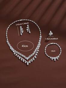 1 set de bijoux avec pendentif en zircone en forme de V, collier, boucles d'oreilles, bracelet, bague 4 pièces - Ensemble boucles d'oreilles, collier, bague et bracelet - Voir 1