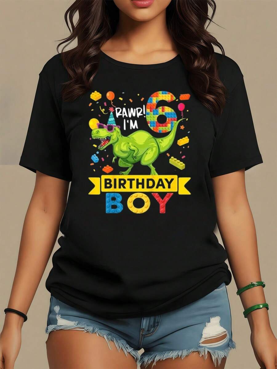 A Cheerful Green Dinosaur Wearing Glasses, Celebrating Amidst Balloons And Confetti, Symbolizes Fun And Youthful Energy. This Modern And Comfortable Women's T-Shirt Is Perfect For Celebrating In Casual Style. - 黑色 - 查看 1