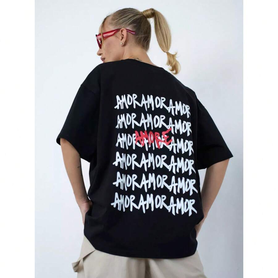 Camiseta de manga corta 100% algodón, estilo nuevo de verano 2025, casual y divertida con estampado de letras a la moda, top fresco y elegante. - Negro - Ver 1