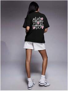 Camiseta de manga corta 100% algodón, elegante y versátil, con estampado de corazones, de longitud media para el verano, estilo europeo y americano, única y de corte holgado. - Negro - Ver 1