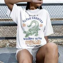 1 camiseta de fútbol universitario Gators Game Day, vintage de Florida, linda para chica o niño, regalo de Navidad para estudiante, camiseta de algodón grueso Gainseville Swamp Taiate. Ofrece un ajuste estructurado, una sensación suave y durabilidad a largo plazo. Perfecta para un estilo casual, para usar en capas o como prenda esencial de uso diario, es transpirable pero resistente: tu nueva camisa favorita. 180g 100% algodón, los diseños están impresos. Unisexo. - Blanco - Ver 1