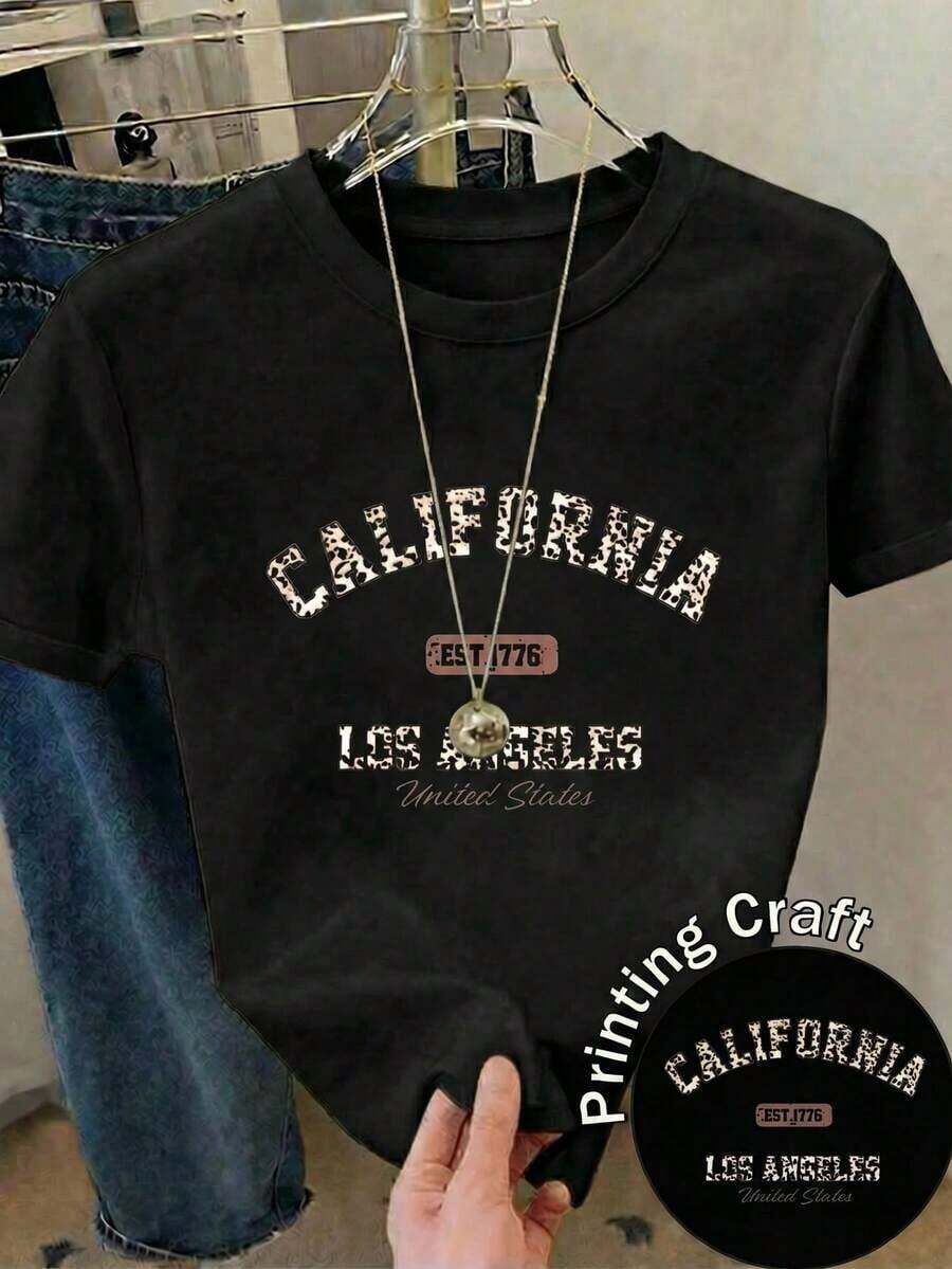 Nueva llegada 2026: camiseta de manga corta con cuello redondo para mujer. Hecho de 100% algodón puro con un corte holgado. Diseño casual y versátil con estampados, una prenda esencial en el armario. Perfecto para el transporte diario, citas informales y moda urbana. - Negro - Ver 1